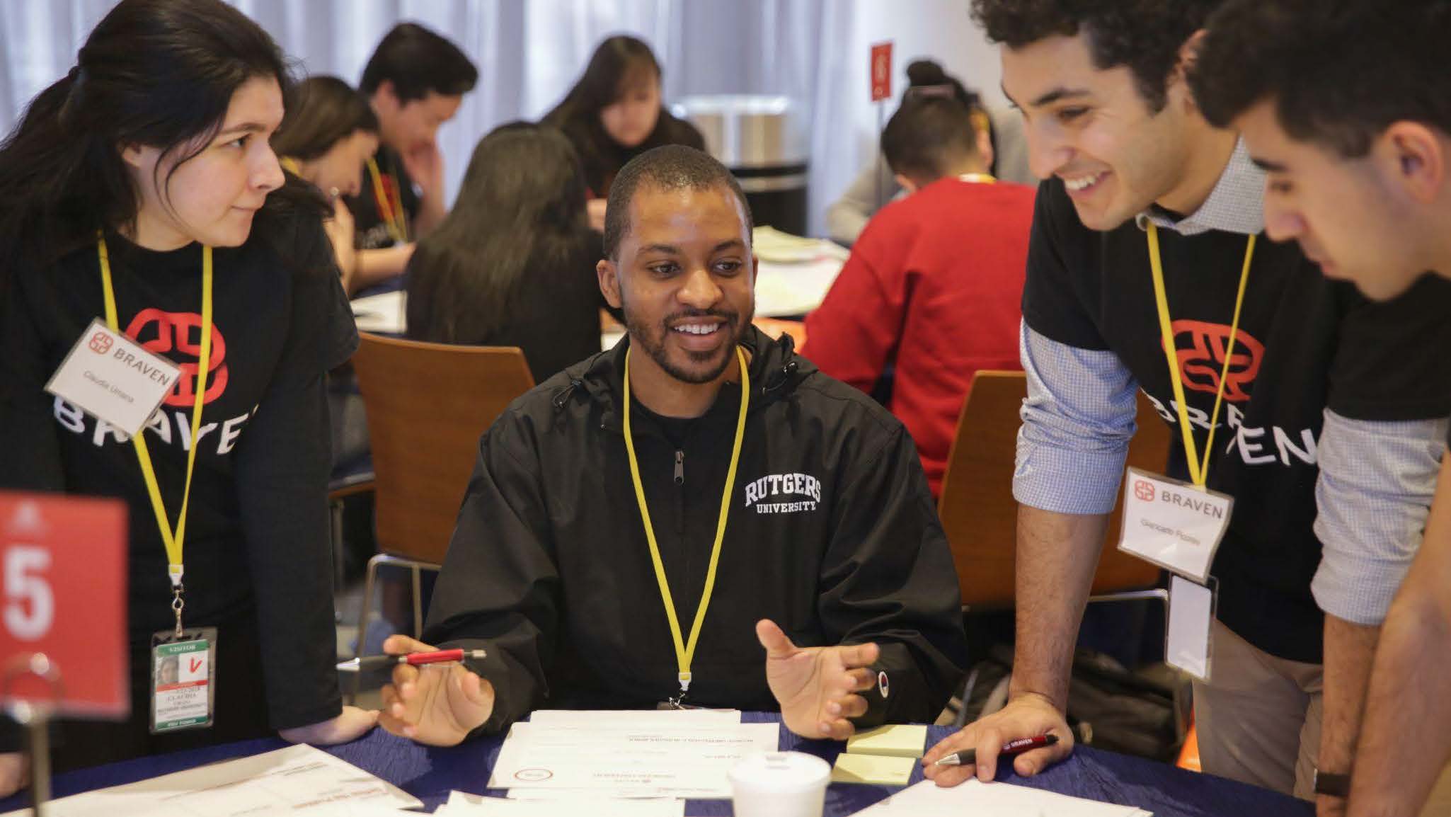 A group of people sitting around a table with papers.
