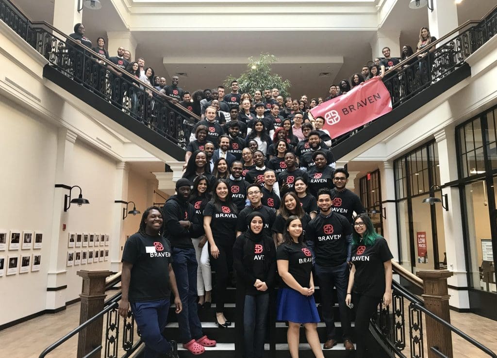A group of people posing for a photo in a building.