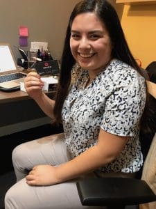 Dania Moctezuma holding her first business card