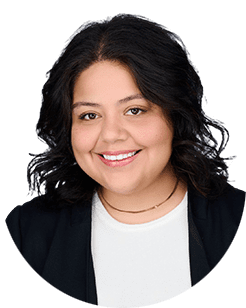 A smiling woman in a black blazer and white shirt.