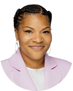 A smiling woman in a pink blazer.