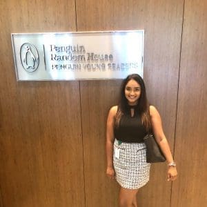 A group of people talking at a table in front of a screen.