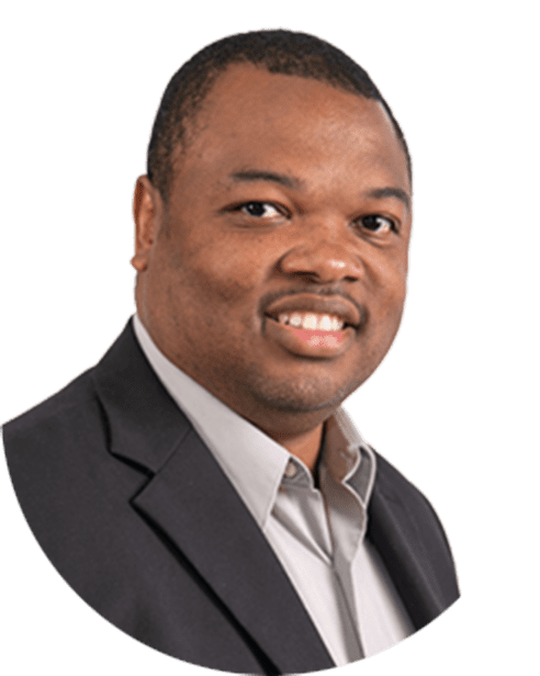 A man in a suit smiling at the camera