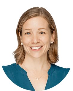 A smiling woman in a blue top.