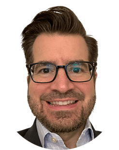 A portrait of a man wearing glasses and a suit.