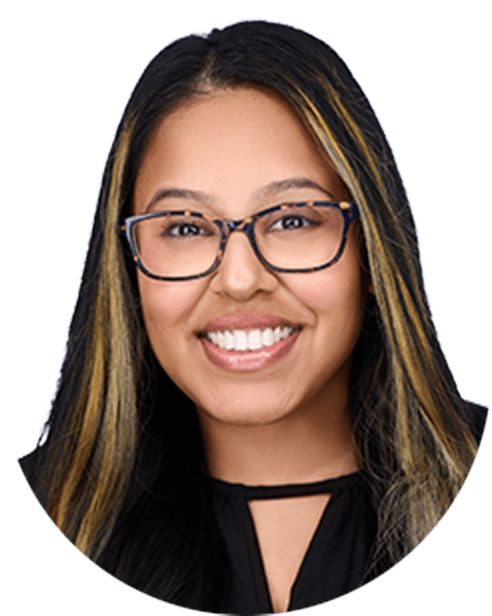 A smiling woman wearing glasses and a black shirt.