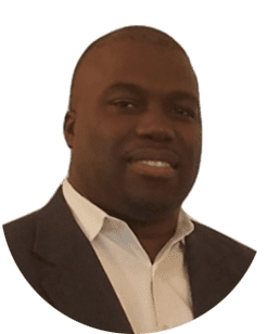 A black man in a suit and white shirt.