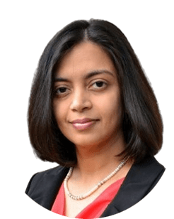 An indian woman wearing a black blazer and red top.