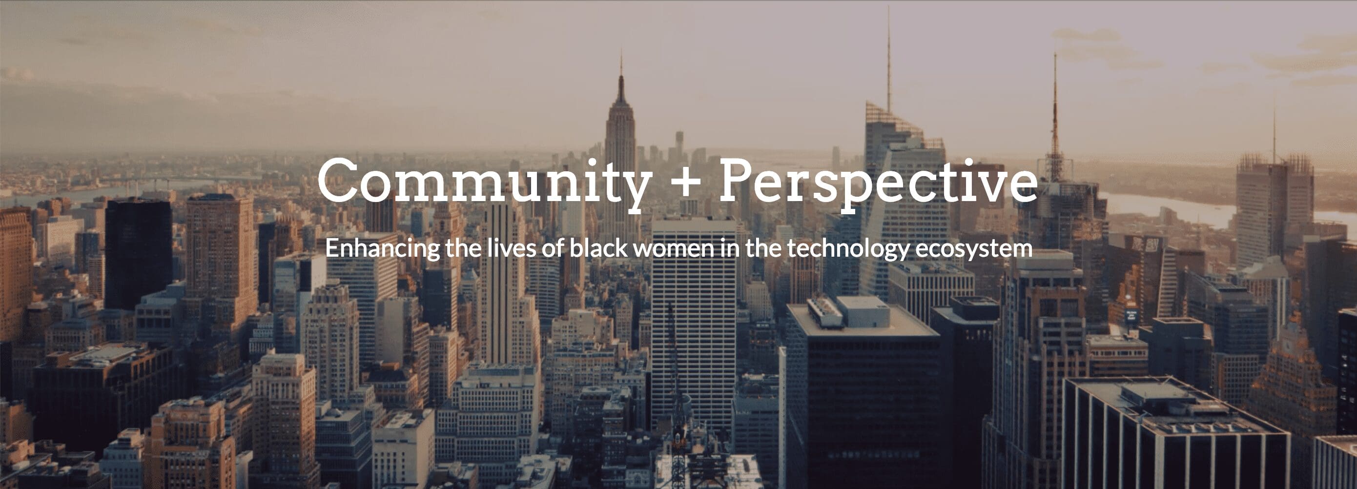 Person with long dark hair wearing a white collared shirt, smiling slightly in a portrait-style photo.