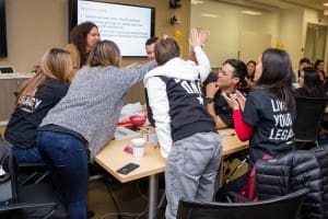 Braven Fellows leaning in and cheering together