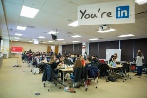Braven Fellows sitting in various cohorts at multiple tables