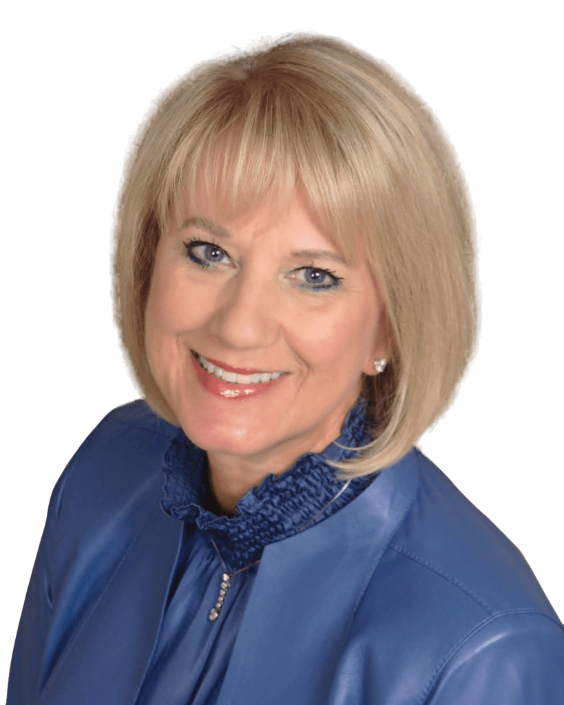 A woman in a blue jacket smiling.