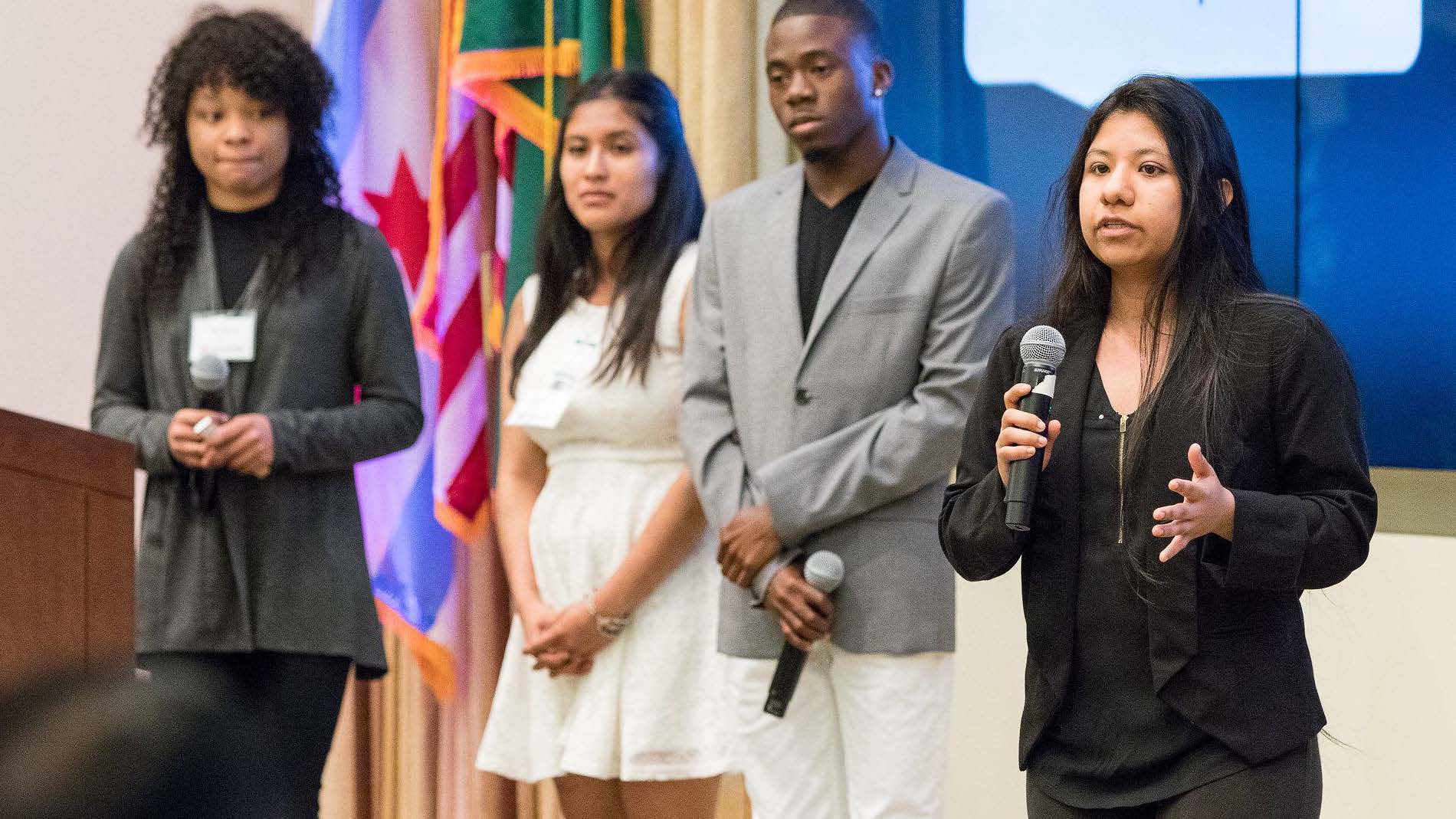 A group of people standing in front of a microphone.