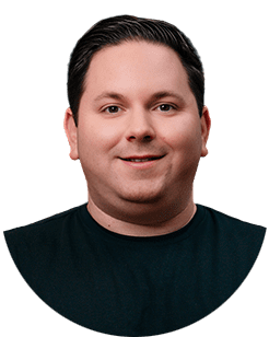 A man in a black shirt smiling for the camera.