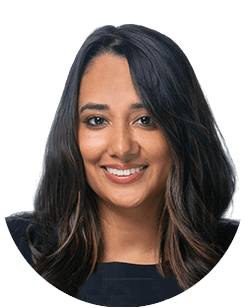 A woman with long, dark hair and a black top smiles at the camera.