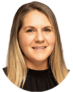 Portrait of a person with long, straight blonde hair, smiling at the camera, wearing a black top.