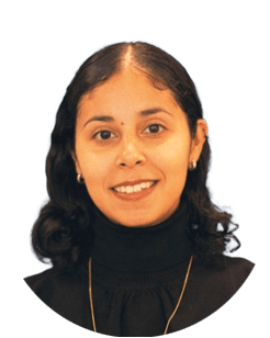 Portrait of a woman with long dark hair wearing a black turtleneck and gold necklace, smiling at the camera against a plain background.