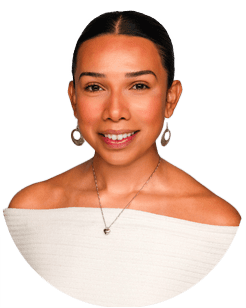 A woman with dark hair pulled back, wearing hoop earrings, a necklace, and an off-the-shoulder white top, smiling at the camera against a plain background.