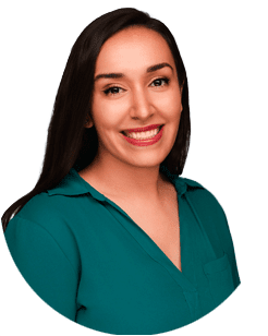 Woman with long dark hair wearing a teal blouse, smiling at the camera against a plain light background.