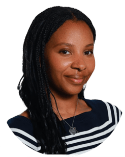Woman with long braided hair wearing a navy top with white stripes and a necklace, smiling at the camera against a plain background.