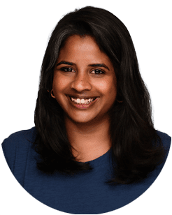 Woman with dark hair and a blue top smiling at the camera against a plain white background.