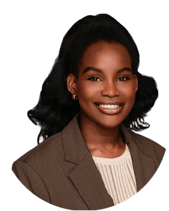 A woman with long black hair, wearing a brown blazer and cream top, smiles at the camera against a plain light background.