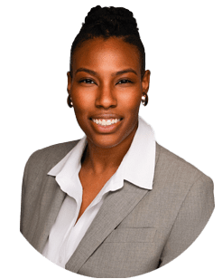 A person wearing a light gray blazer and white collared shirt, smiling at the camera against a plain white background.