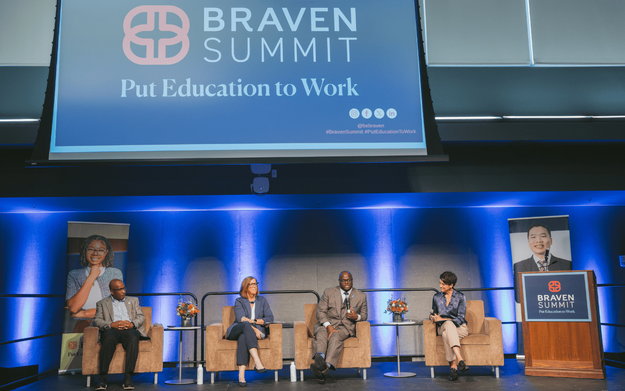 Four panelists sit on stage beneath a large screen reading "Braven Summit: Put Education to Work," with two portraits and a podium on either side.