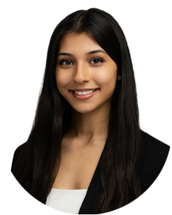 Portrait of a young woman with long dark hair, wearing a black blazer over a white top, smiling at the camera against a plain background.